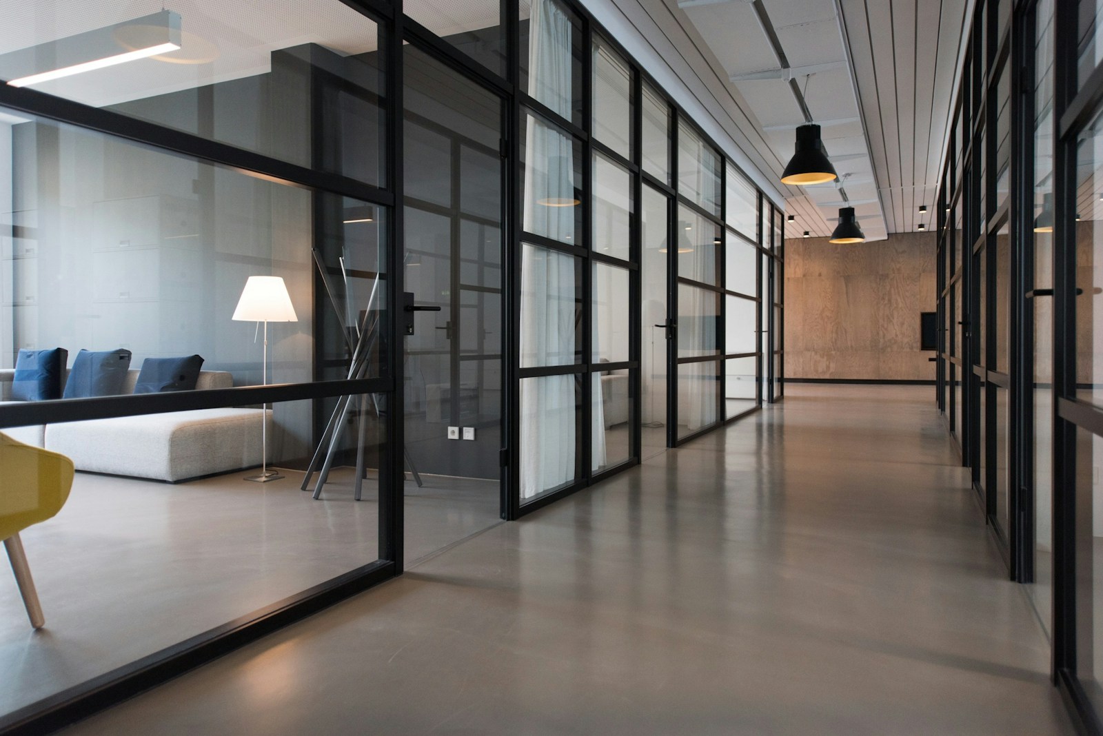 Modern office with glass meeting rooms and clean floors